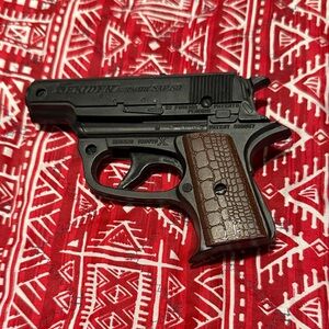 Toy Pistol About 5.5”x4”.  Black and Brown Great Condition.  No Chips or Cracks